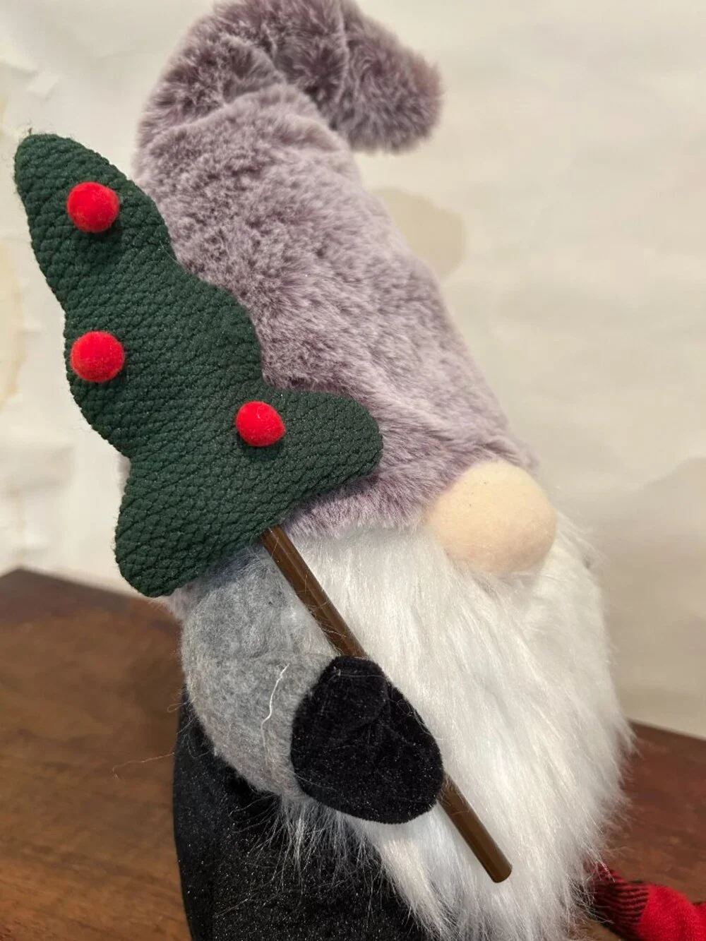 Christmas Holiday Gnome with gray cap and wispy white beard, holding tree